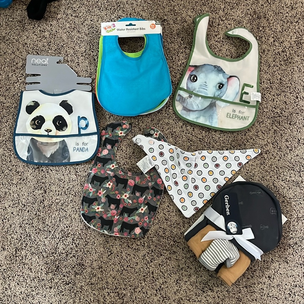 Lot of baby bibs + towels- most never used